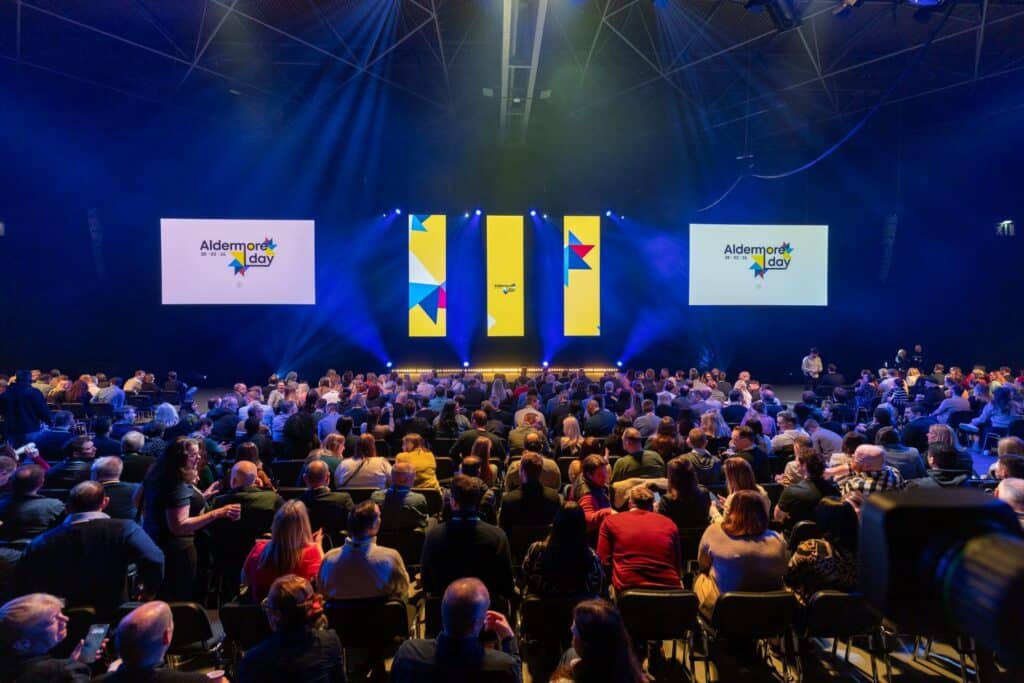 On Event Production Company | Live, Hybrid and Virtual Event Production | Aldemore Day stage and filled seats