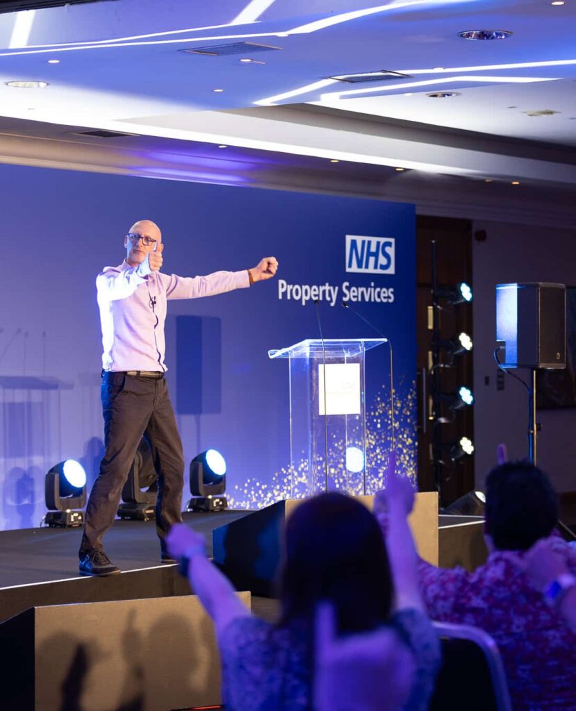 On Event Production Company | Live, Hybrid and Virtual Event Production | Presenter on stage